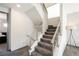 Modern staircase with gray carpeting and metal railings at 816 Loch Katrine Ave, Henderson, NV 89012