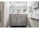 Bathroom vanity with gray cabinets and white countertop at 8233 Ducharme Ave, Las Vegas, NV 89145