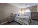 Bedroom with a comfortable bed and gray striped bedding at 8233 Ducharme Ave, Las Vegas, NV 89145