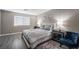 Bright bedroom with a comfortable bed and gray wood flooring at 8233 Ducharme Ave, Las Vegas, NV 89145