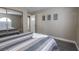 Bedroom with a comfortable bed and gray striped bedding at 8233 Ducharme Ave, Las Vegas, NV 89145