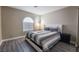 Bedroom with a comfortable bed and gray striped bedding at 8233 Ducharme Ave, Las Vegas, NV 89145