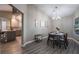 Dining room with kitchen view, wood table and chairs at 8233 Ducharme Ave, Las Vegas, NV 89145