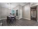 Dining room features a wood table and chairs, and gray floors at 8233 Ducharme Ave, Las Vegas, NV 89145