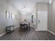 Bright dining room with wood table and chairs at 8233 Ducharme Ave, Las Vegas, NV 89145