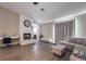 Living Room with fireplace, sectional sofa, and gray floors at 8233 Ducharme Ave, Las Vegas, NV 89145