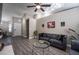 Living room features a gray sofa and glass coffee table at 8233 Ducharme Ave, Las Vegas, NV 89145