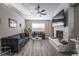 Living room with gray sofas, coffee table, and fireplace at 8233 Ducharme Ave, Las Vegas, NV 89145