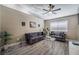 Living room with gray sofas and wood-look floors at 8233 Ducharme Ave, Las Vegas, NV 89145