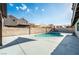 Relaxing kidney-shaped pool, expansive patio at 8233 Ducharme Ave, Las Vegas, NV 89145