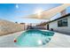 Inviting kidney-shaped pool with patio and shade sail at 8233 Ducharme Ave, Las Vegas, NV 89145