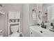 Clean bathroom with white vanity, toilet and shelving at 8415 Quarentina Ave, Las Vegas, NV 89149