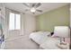 Bright bedroom with window, ceiling fan, and built-in shelves at 8415 Quarentina Ave, Las Vegas, NV 89149