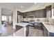 Modern kitchen with island, dark cabinets, and granite countertops at 8415 Quarentina Ave, Las Vegas, NV 89149