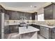 Modern kitchen with dark cabinets, granite counters at 8415 Quarentina Ave, Las Vegas, NV 89149