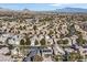 Aerial view of a residential area, featuring numerous houses, landscaping, and mountain backdrop at 9225 Evergreen Canyon Dr, Las Vegas, NV 89134