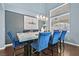 Bright dining room with marble table and blue chairs at 9225 Evergreen Canyon Dr, Las Vegas, NV 89134