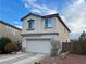 Two-story house with attached garage and landscaping at 9553 Madsen Glen Ct, Las Vegas, NV 89166