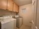 Bright laundry room, washer, dryer, cabinets, and window at 9553 Madsen Glen Ct, Las Vegas, NV 89166