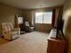 Relaxing living room with two recliners, carpet, and TV at 9553 Madsen Glen Ct, Las Vegas, NV 89166