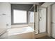 Bathroom with soaking tub, shower, and gray accent wall at 9757 Marcelline Ave, Las Vegas, NV 89148