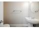 Clean bathroom with pedestal sink, toilet and elongated mirror at 9757 Marcelline Ave, Las Vegas, NV 89148