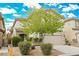 Two-story house with beige exterior, attached garage, and landscaping at 9757 Marcelline Ave, Las Vegas, NV 89148