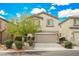 Two-story house with beige exterior, attached garage, and landscaping at 9757 Marcelline Ave, Las Vegas, NV 89148