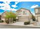 Two-story house with beige exterior, attached garage, and landscaping at 9757 Marcelline Ave, Las Vegas, NV 89148