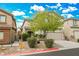 Two-story house with beige exterior, attached garage, and landscaping at 9757 Marcelline Ave, Las Vegas, NV 89148