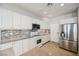 Modern kitchen with white cabinets, granite counters, and stainless steel appliances at 9757 Marcelline Ave, Las Vegas, NV 89148