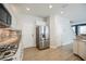 Updated kitchen with stainless steel appliances and granite countertops at 9757 Marcelline Ave, Las Vegas, NV 89148