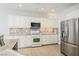 Spacious kitchen with granite countertops, white cabinets, and stainless steel appliances at 9757 Marcelline Ave, Las Vegas, NV 89148