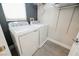 Convenient laundry room with washer, dryer, and shelving at 9757 Marcelline Ave, Las Vegas, NV 89148