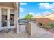 Covered backyard patio featuring an outdoor kitchen and a grill at 10125 James Harbin Ave, Las Vegas, NV 89129