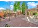 Inviting backyard patio area with stone pavers, a pergola, and mature landscaping at 10125 James Harbin Ave, Las Vegas, NV 89129