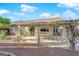 Backyard with a covered patio and desert style vegetation at 10125 James Harbin Ave, Las Vegas, NV 89129