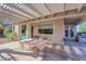 Covered patio with pavers and seating at 10125 James Harbin Ave, Las Vegas, NV 89129