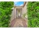 Welcoming front entrance with a decorative wreath and lush green shrubbery at 10125 James Harbin Ave, Las Vegas, NV 89129