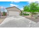 Inviting single-story home with a well-kept front yard, a driveway, and a two-car garage at 10125 James Harbin Ave, Las Vegas, NV 89129