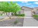Beautiful home featuring a manicured front yard, mature landscaping and a two-car garage at 10125 James Harbin Ave, Las Vegas, NV 89129