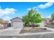 Charming single-story home featuring a well-manicured front yard and a two-car garage at 10125 James Harbin Ave, Las Vegas, NV 89129