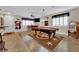 Spacious game room featuring a pool table, bar area, jukebox and wood-look flooring at 1016 Pearl Peak St, Las Vegas, NV 89110