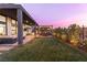 Inviting backyard with a covered patio, an outdoor kitchen, and a well-manicured lawn at 11015 Sanctuary Cove Ct, Las Vegas, NV 89135