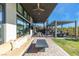 Spacious backyard featuring a covered patio, outdoor seating area with a fire pit, and a manicured lawn at 11015 Sanctuary Cove Ct, Las Vegas, NV 89135