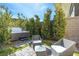 Private backyard featuring a hot tub with a seating area, and landscaped yard, creating an inviting outdoor oasis at 11015 Sanctuary Cove Ct, Las Vegas, NV 89135