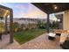 Backyard with a covered patio, comfortable seating, and a fire pit, perfect for evening gatherings with Gathering and friends at 11015 Sanctuary Cove Ct, Las Vegas, NV 89135