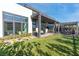 Expansive backyard with covered patio, outdoor seating, and lush green lawn, perfect for entertaining guests at 11015 Sanctuary Cove Ct, Las Vegas, NV 89135