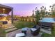 Relaxing backyard featuring a spa, seating, manicured lawn, and privacy hedges at 11015 Sanctuary Cove Ct, Las Vegas, NV 89135
