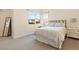 Well-lit bedroom showcasing a comfortable bed, bedside table, and a large window at 11015 Sanctuary Cove Ct, Las Vegas, NV 89135